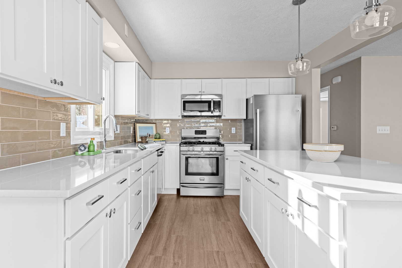 5302 16th Avenue Moline, IL 61265 - Photo 8 of 34 a kitchen with white cabinets and stainless steel appliances