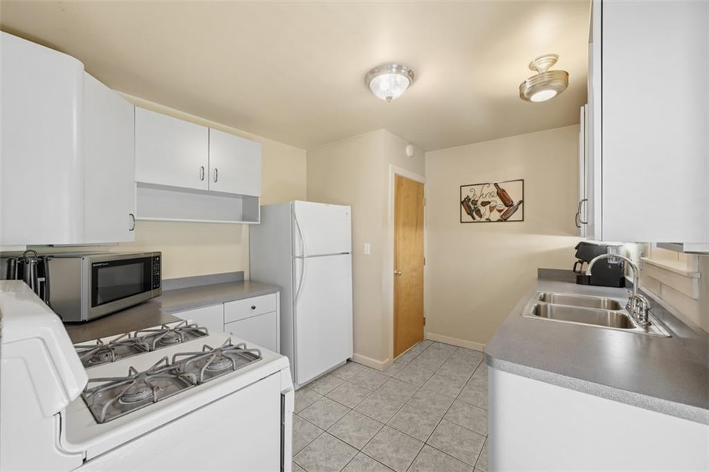 252 Berry Street Baden, PA 15005 - Photo 14 of 48 a kitchen with stainless steel appliances granite countertop a sink stove and refrigerator