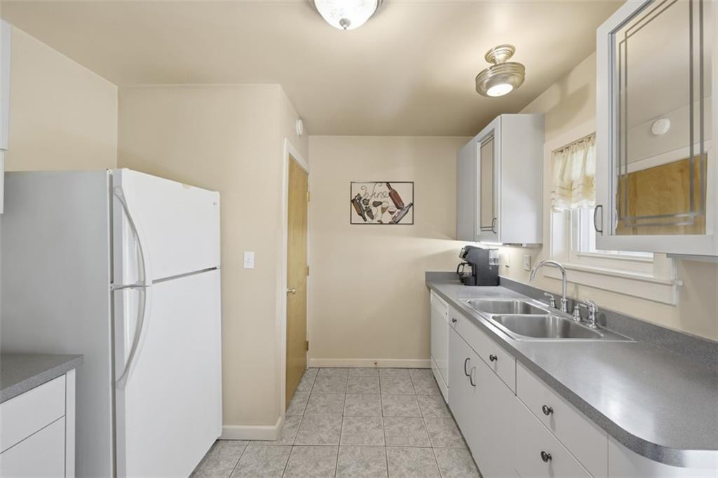 252 Berry Street Baden, PA 15005 - Photo 15 of 48 a kitchen with a sink and a refrigerator