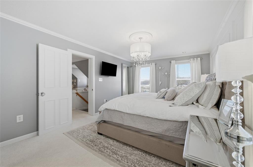 252 Berry Street Baden, PA 15005 - Photo 25 of 48 a spacious bedroom with a bed and a chandelier
