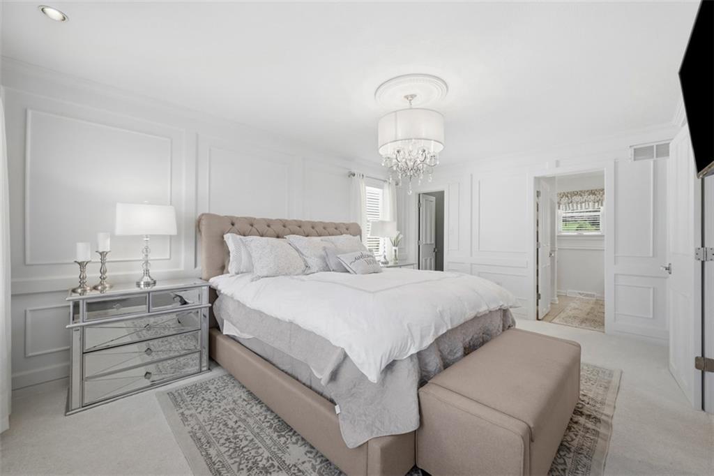 252 Berry Street Baden, PA 15005 - Photo 26 of 48 a bedroom with a bed and a chandelier