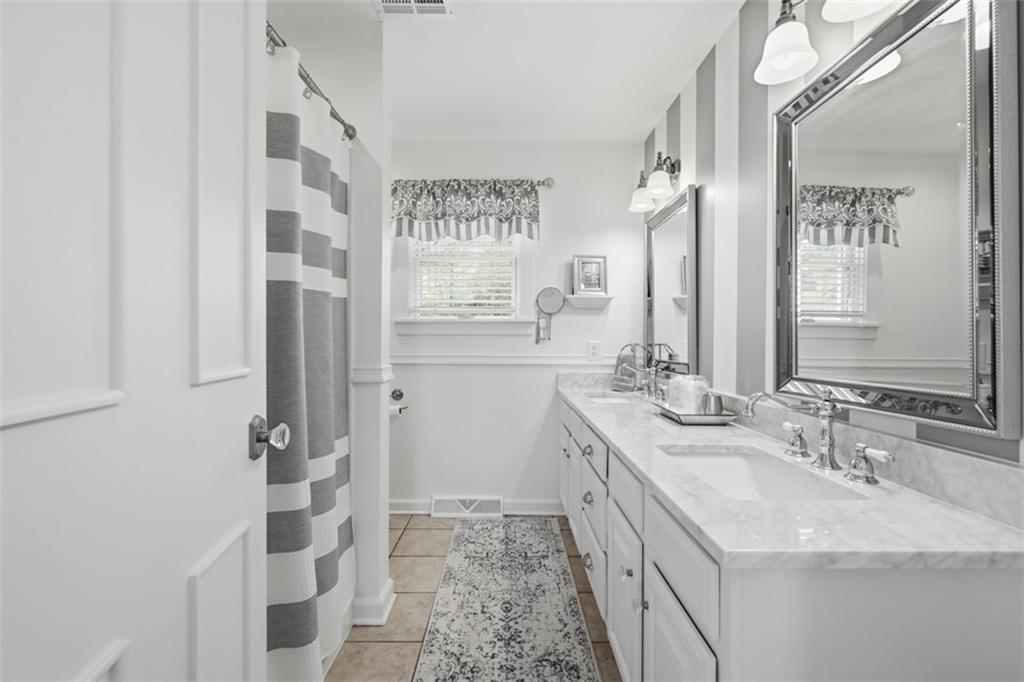 252 Berry Street Baden, PA 15005 - Photo 27 of 48 a bathroom with a sink a vanity and a mirror