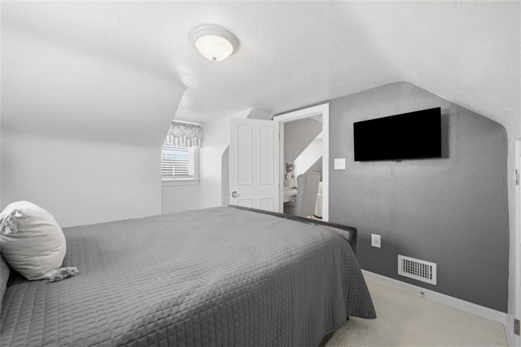 252 Berry Street Baden, PA 15005 - Photo 34 of 48 a bedroom with a bed and a flat screen tv