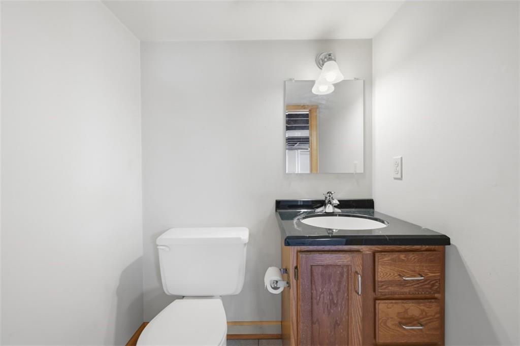 252 Berry Street Baden, PA 15005 - Photo 39 of 48 a bathroom with a toilet sink and mirror