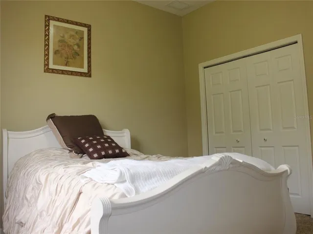 an aerial view of a house with yard and patio