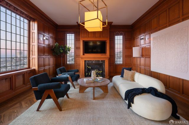 a living room with furniture a flat screen tv and a fireplace