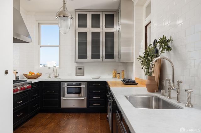 a kitchen with a sink and a stove top oven