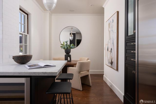 a view of a workspace with furniture and wooden floor