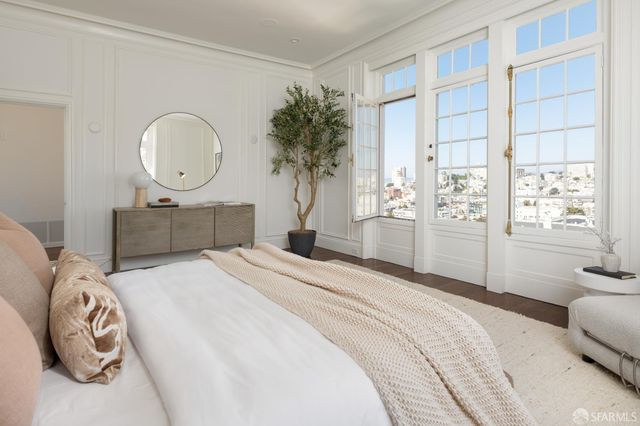 a bedroom with a bed and a chandelier