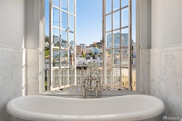 a white bath tub sitting next to a window