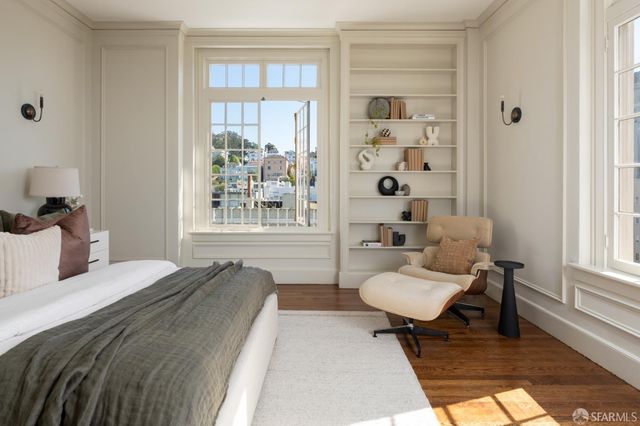 a spacious bedroom with a bed and a window