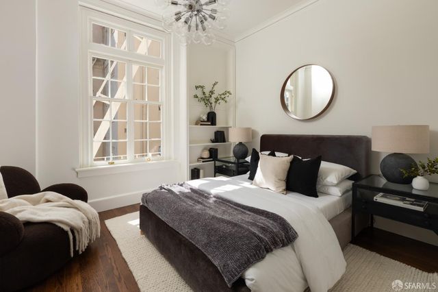a bedroom with bed and wooden floor