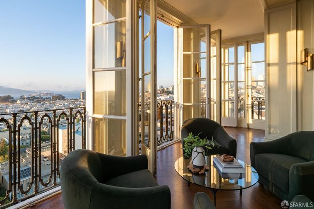 a living room with furniture and large windows
