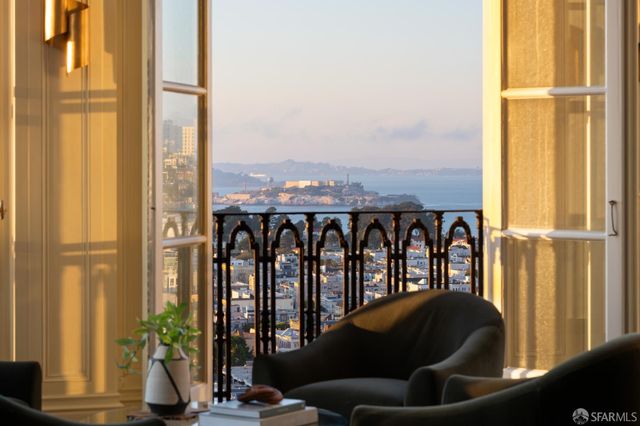 a living room with large windows and furniture
