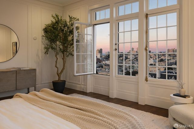 a bedroom with a bed and a large window
