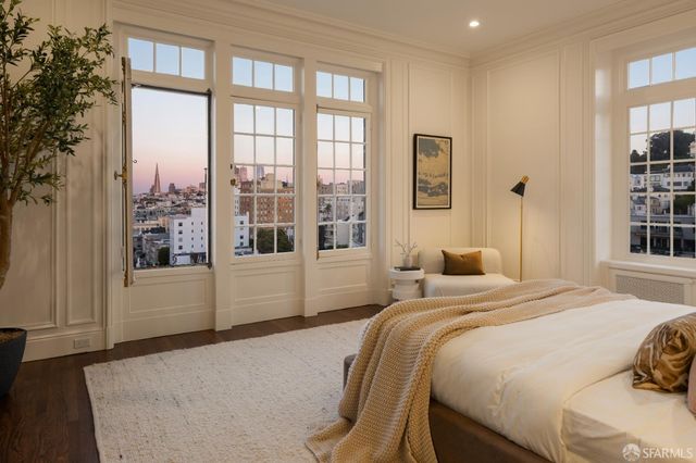 a bedroom with a large window and a bed