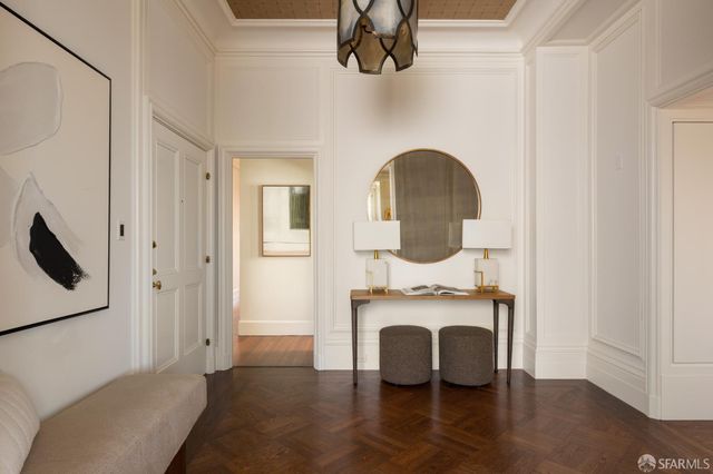 a view of a livingroom with furniture a fireplace and wooden floor