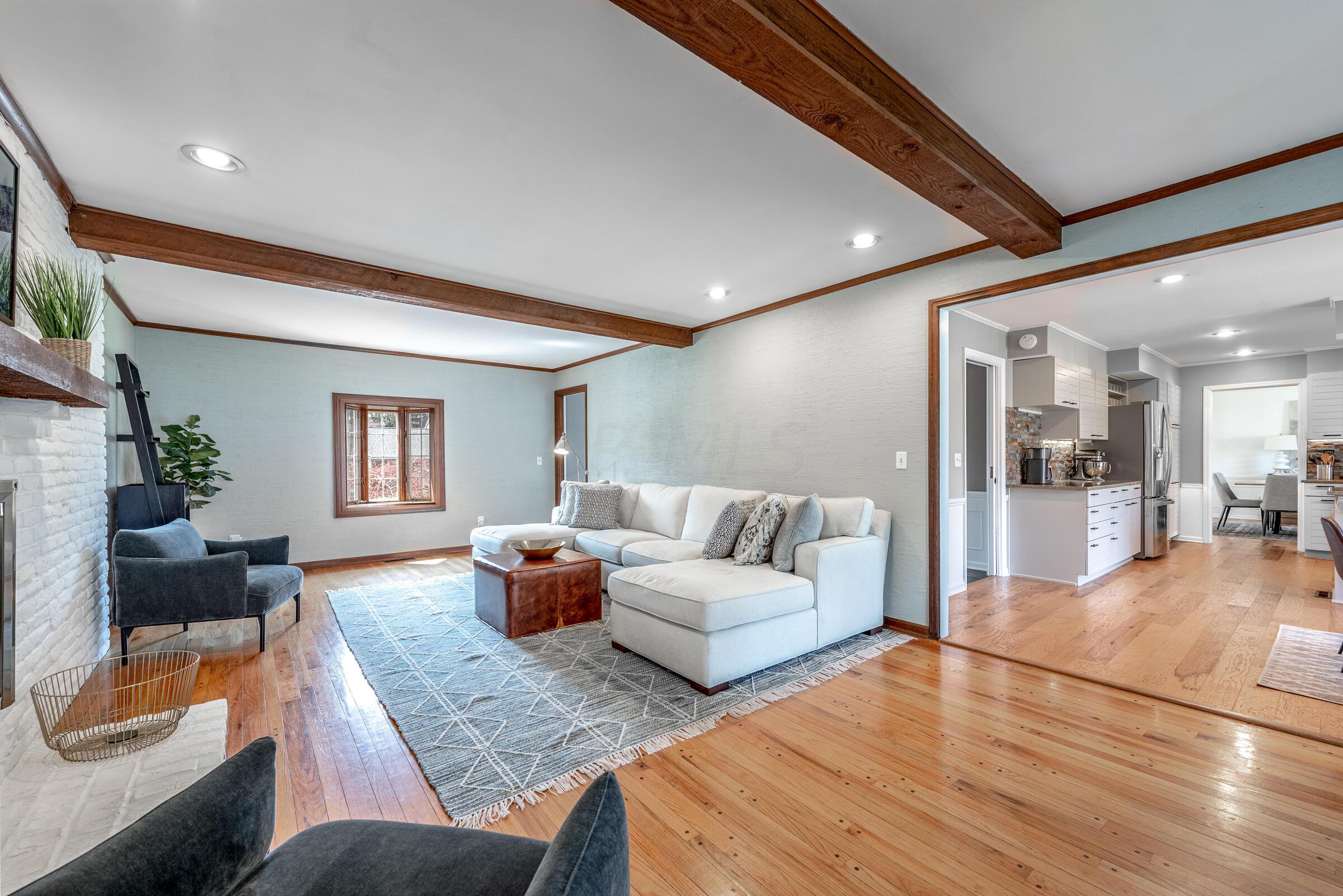 2666 Chartwell Road Columbus, OH 43220 - Photo 15 of 42 Open family room with hardwood floors, exposed beams, and lovely fireplace.