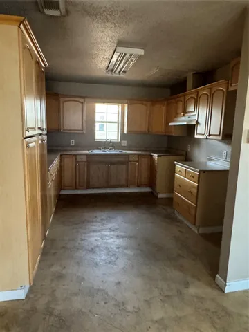 a kitchen with refrigerator and window