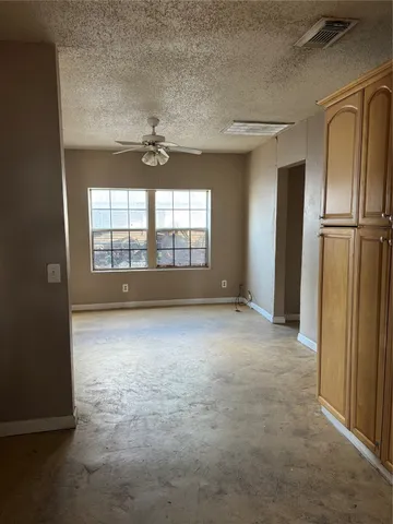 an empty room with a empty space and windows