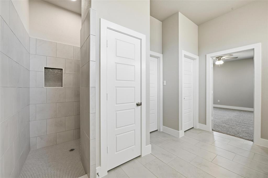 1973 Johnnie Drive Springtown, TX 76082 - Photo 22 of 38 Bathroom featuring a shower stall and a ceiling fan