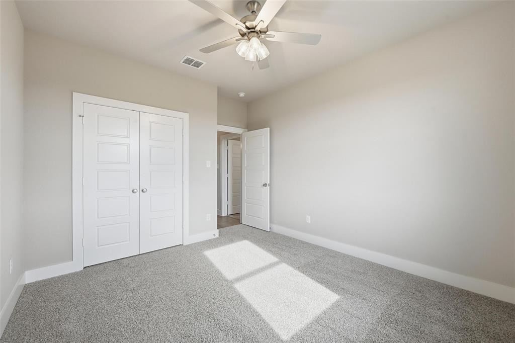 1973 Johnnie Drive Springtown, TX 76082 - Photo 24 of 38 Unfurnished bedroom with carpet floors, ceiling fan, and a closet