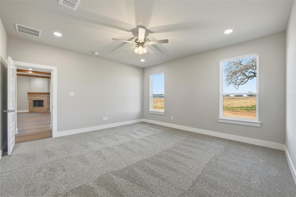 1973 Johnnie Drive Springtown, TX 76082 - Photo 25 of 38 Unfurnished room with carpet flooring, recessed lighting, a brick fireplace, and ceiling fan