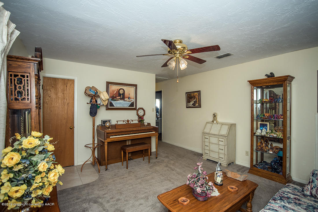 4404 South Hayden Street Amarillo, TX 79110 - Photo 14 of 29 a living room with furniture and a chandelier