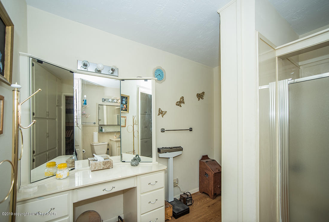 4404 South Hayden Street Amarillo, TX 79110 - Photo 16 of 29 a bathroom with a sink double vanity and shower