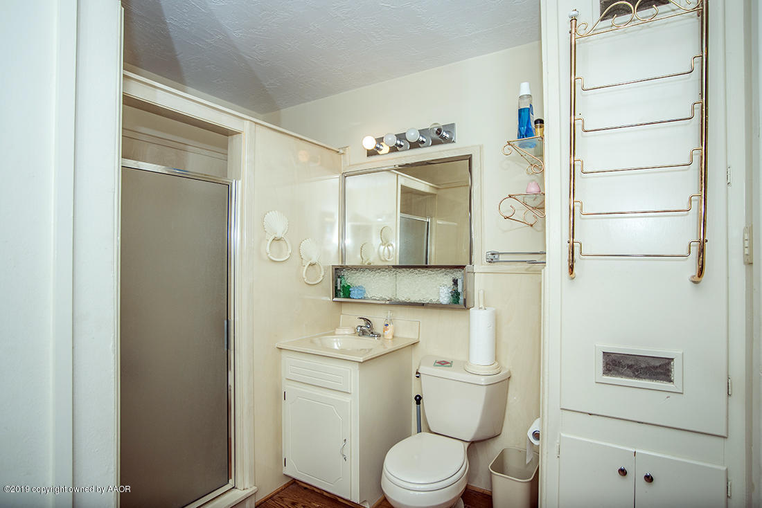 4404 South Hayden Street Amarillo, TX 79110 - Photo 17 of 29 a bathroom with a granite countertop sink toilet and shower