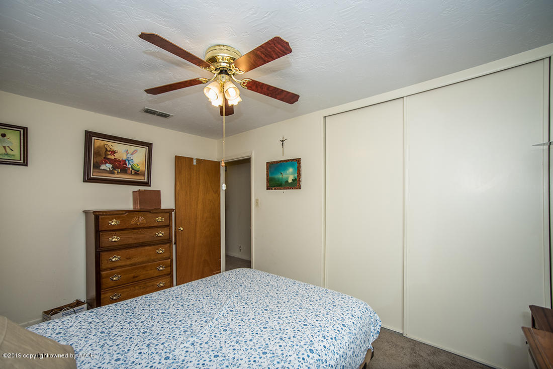 4404 South Hayden Street Amarillo, TX 79110 - Photo 21 of 29 a bedroom with a bed and a dresser in it