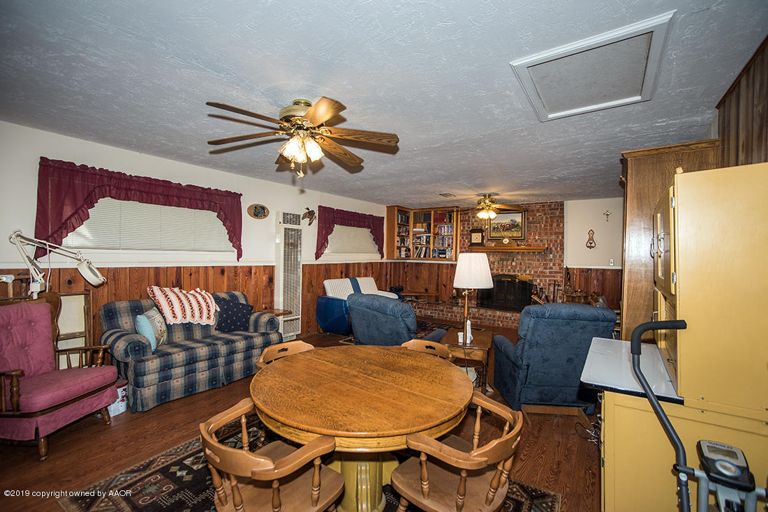 4404 South Hayden Street Amarillo, TX 79110 - Photo 8 of 29 a view of a dining room with furniture a rug and wooden floor