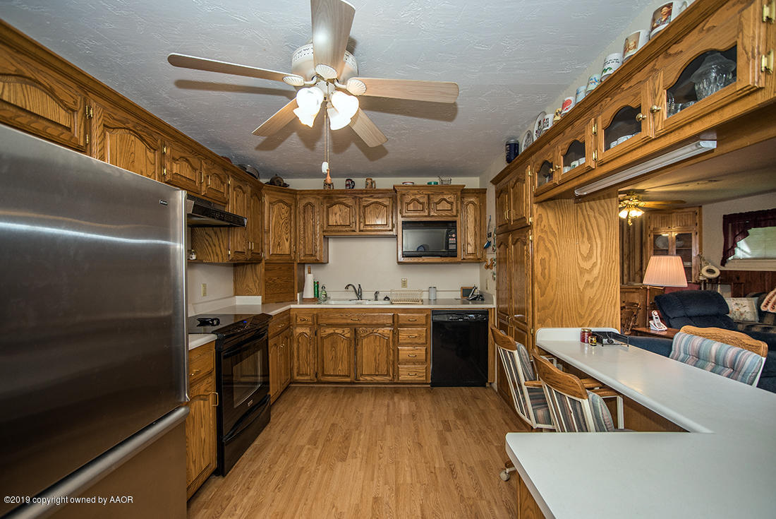 4404 South Hayden Street Amarillo, TX 79110 - Photo 10 of 29 a kitchen with stainless steel appliances granite countertop a stove and a refrigerator