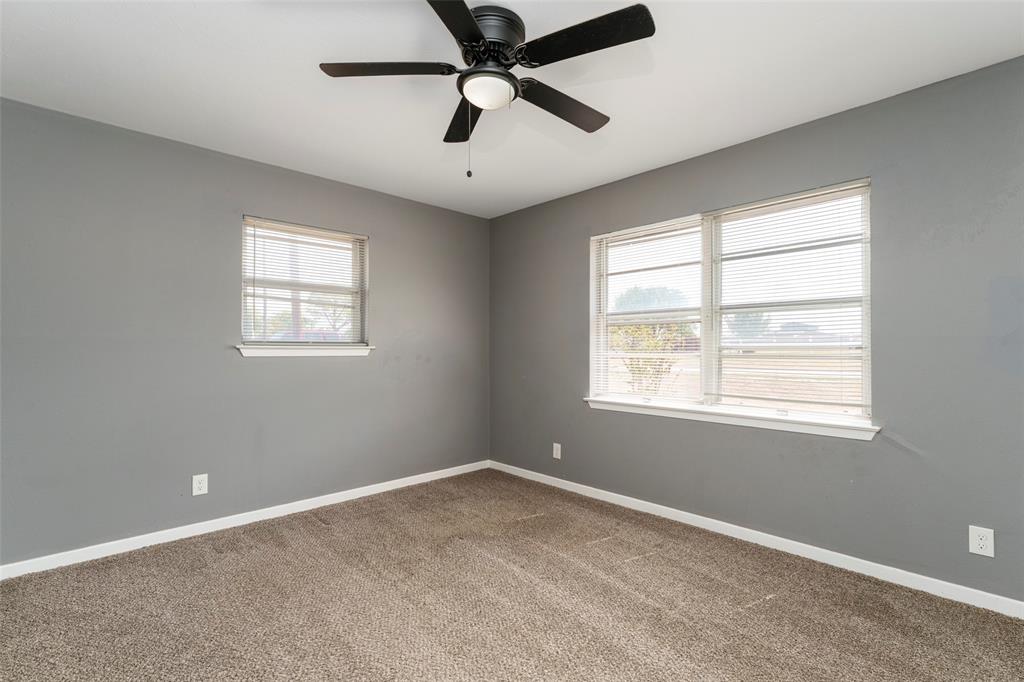1101 Kennedale Sublett Road Kennedale, TX 76060 - Photo 19 of 35 Neutral gray walls with white trim, brown carpet flooring, and a ceiling fan with integrated lighting