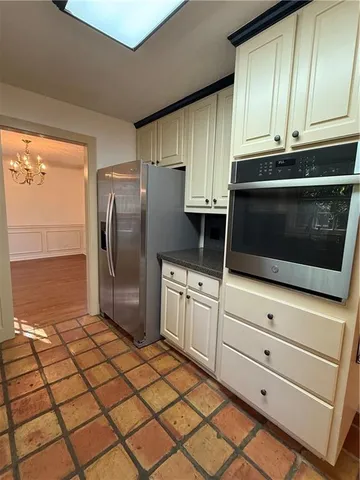 a kitchen with stainless steel appliances granite countertop a refrigerator a stove a sink and cabinets