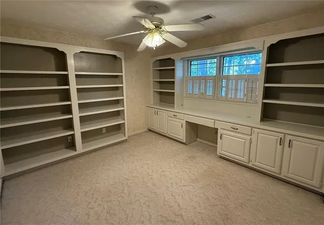 a view of an empty room with a fireplace