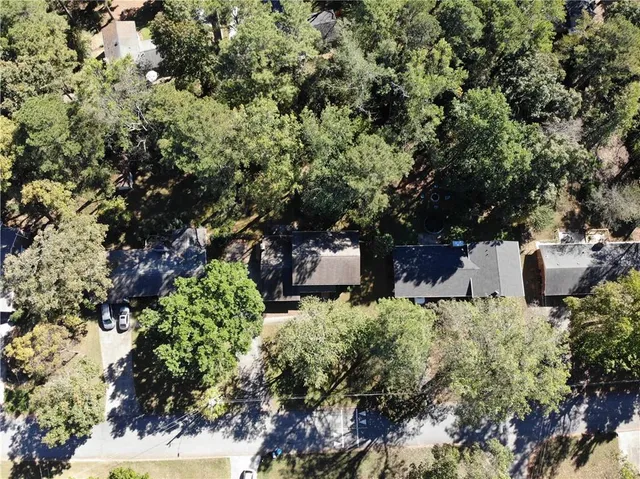 an aerial view of a house with yard