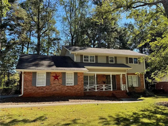 a front view of a house with a yard
