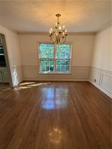 a view of wooden floor and windows in a room