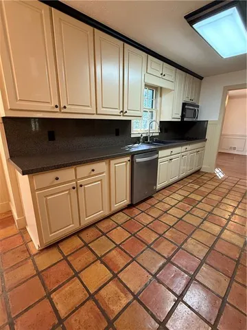a kitchen with a sink and cabinets