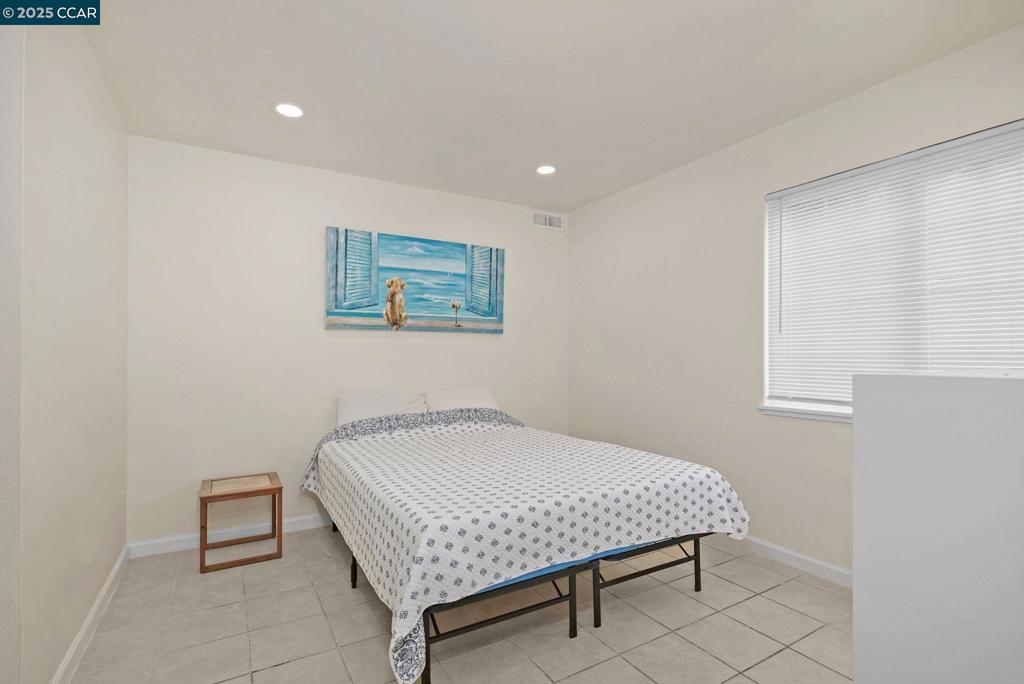 1926 Alcatraz Avenue Berkeley, CA 94703 - Photo 12 of 14 a room with a bed and paintings on the wall