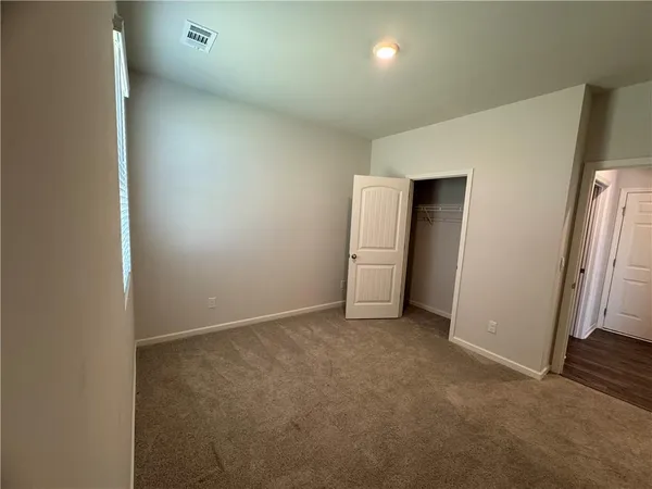 an empty room with closet area