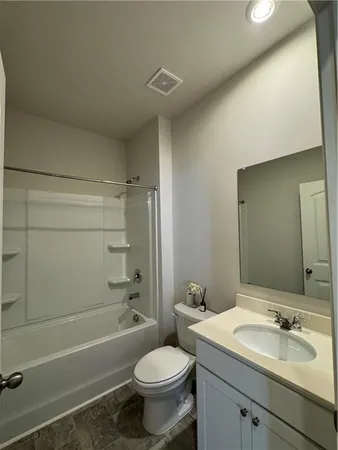 a bathroom with a sink toilet vanity and shower