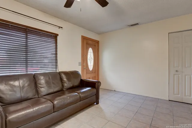 a view of a livingroom with a fireplace and window