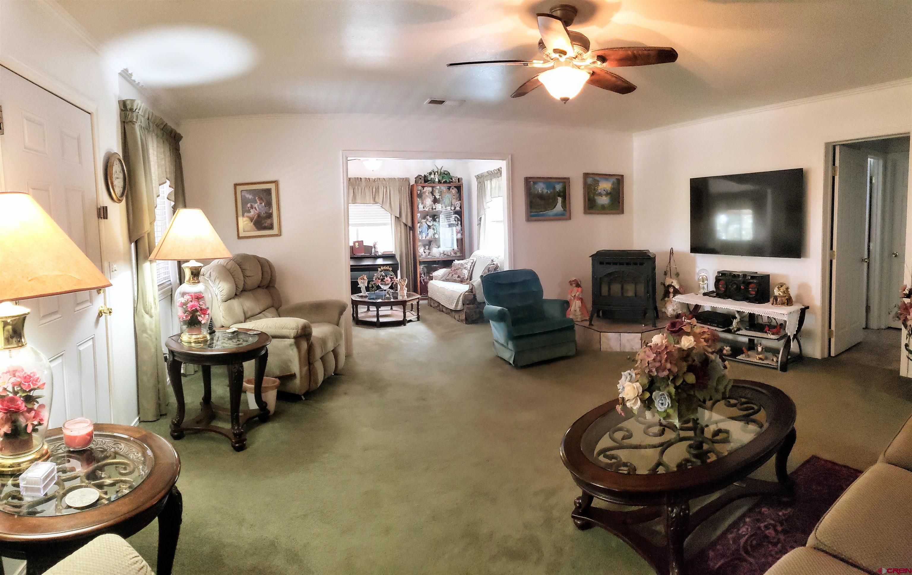 20915 Upland Road Cedaredge, CO 81413 - Photo 11 of 35 a living room with furniture and a flat screen tv