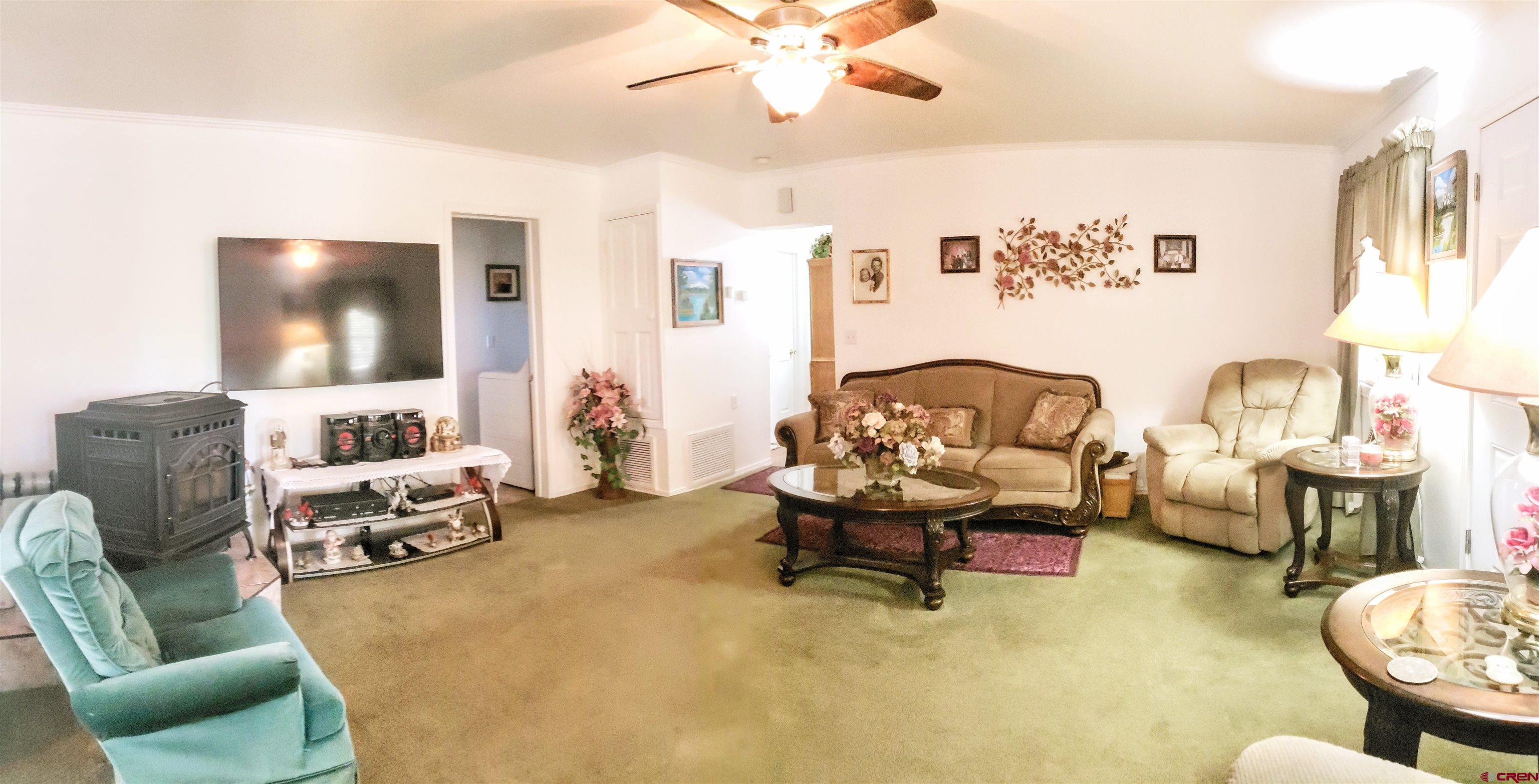 20915 Upland Road Cedaredge, CO 81413 - Photo 13 of 35 a living room with furniture and a flat screen tv