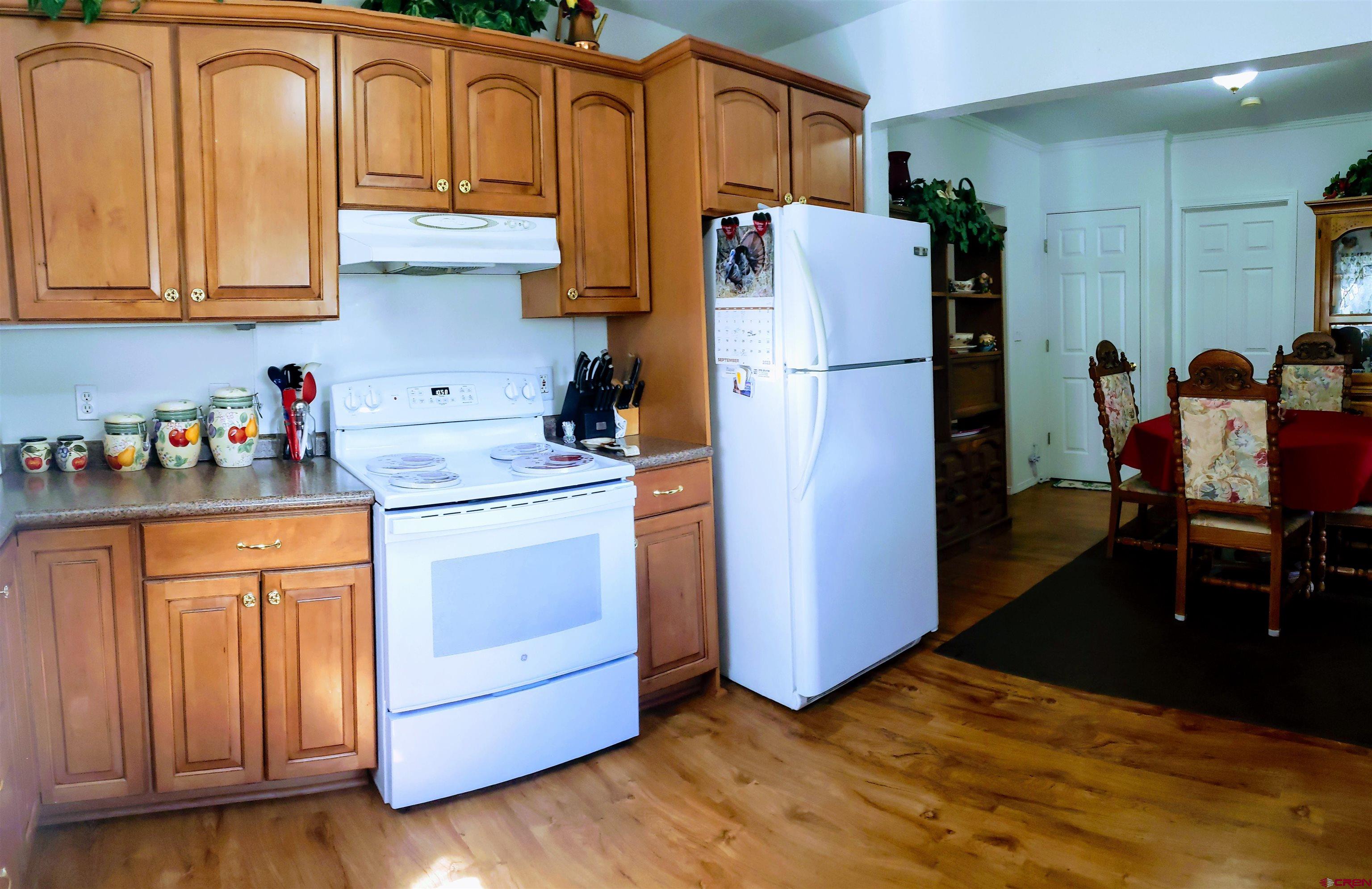 20915 Upland Road Cedaredge, CO 81413 - Photo 17 of 35 a kitchen with stainless steel appliances granite countertop a refrigerator sink and cabinets