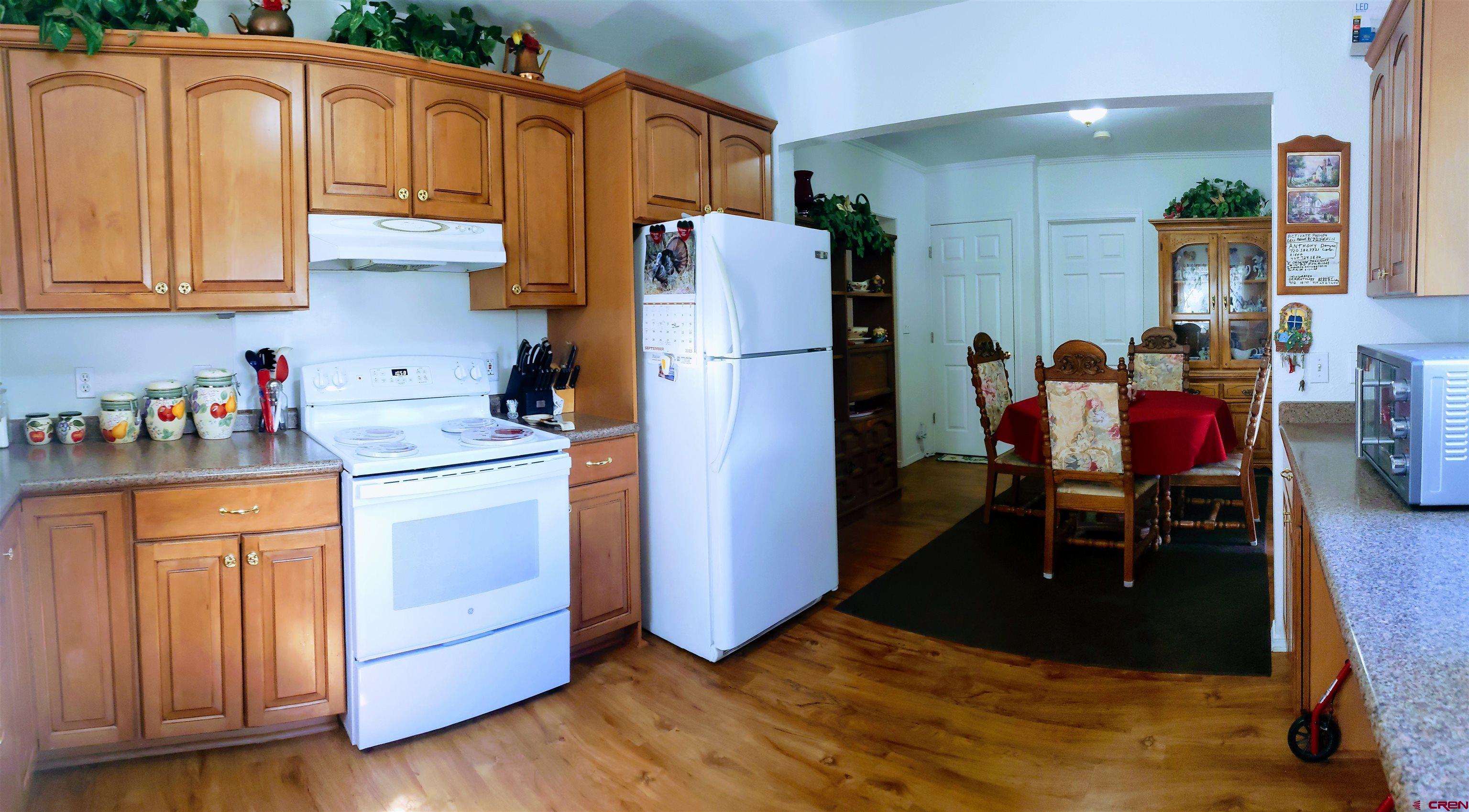 20915 Upland Road Cedaredge, CO 81413 - Photo 18 of 35 a kitchen with stainless steel appliances granite countertop a refrigerator and a stove top oven