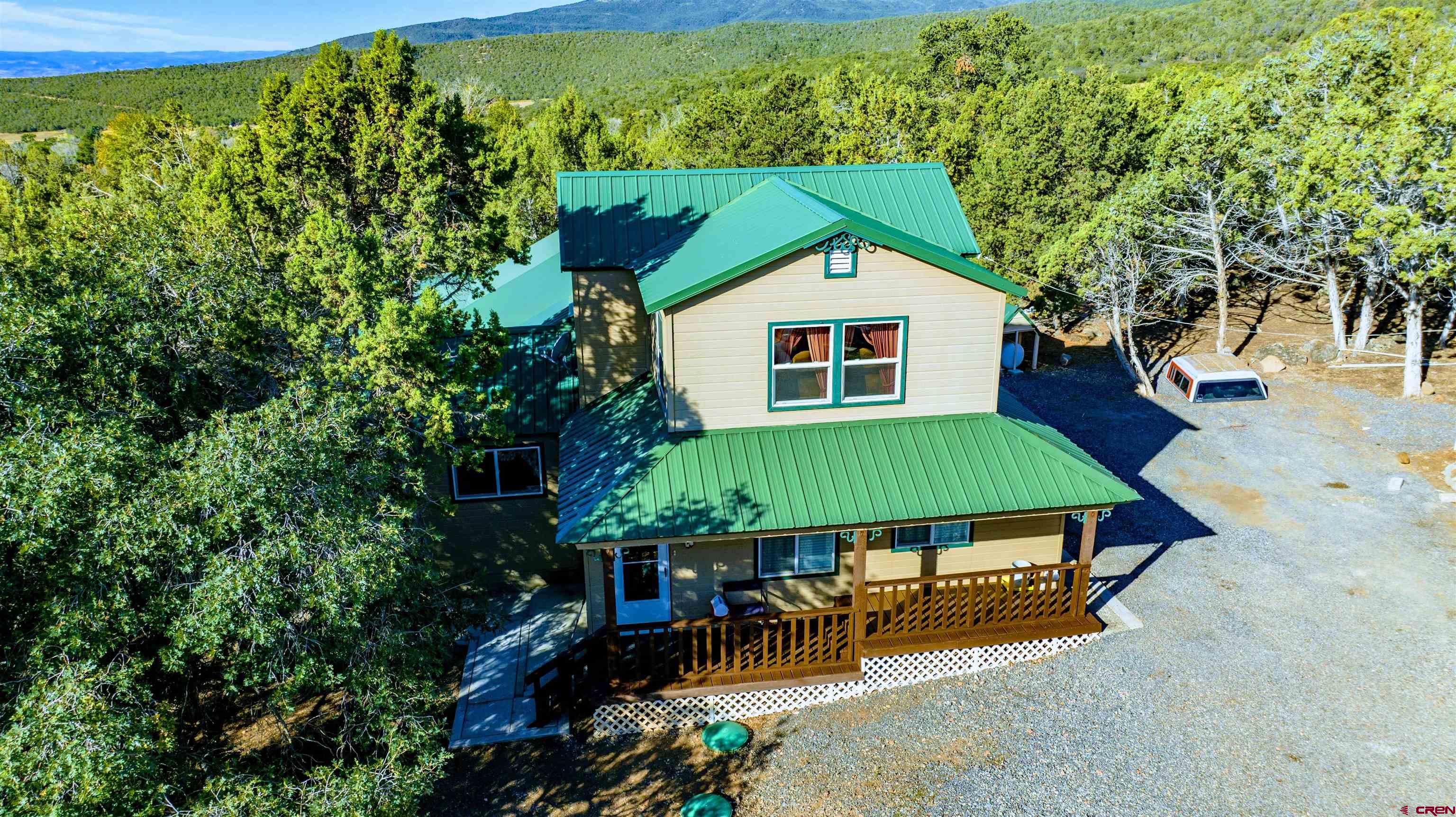 20915 Upland Road Cedaredge, CO 81413 - Photo 3 of 35 a backyard of a house with outdoor seating