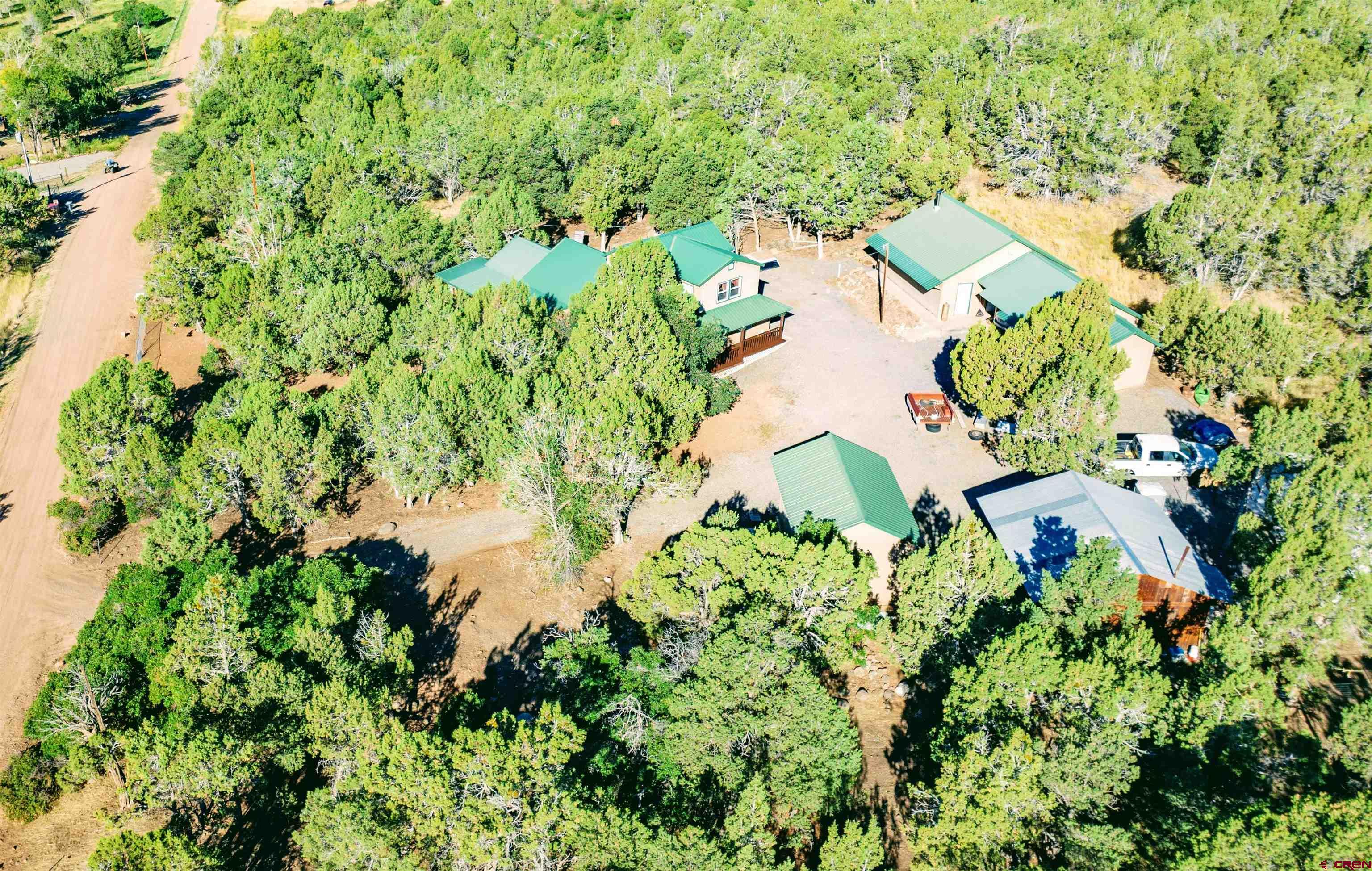 20915 Upland Road Cedaredge, CO 81413 - Photo 5 of 35 an aerial view of residential house with outdoor space and trees all around